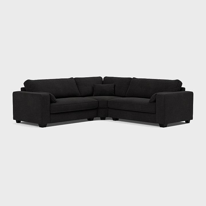 Modern black double corner sofa with clean lines and plush cushions on a light background