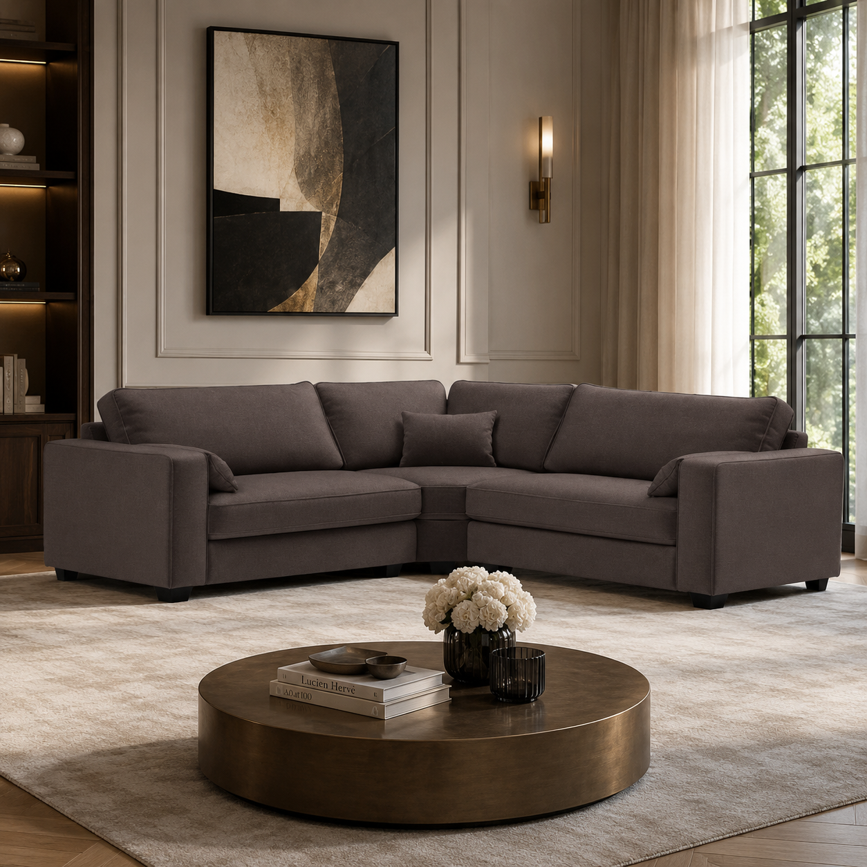 Luxury grey sectional sofa in modern living room with round coffee table and abstract art