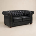 Black leather Chesterfield sofa with tufted back, rolled arms, and nailhead trim