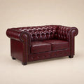 Luxury burgundy leather Chesterfield sofa with tufted back and rolled arms, ideal for elegant living rooms.