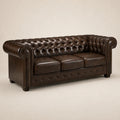 Luxury brown leather Chesterfield sofa with tufted back and rolled arms, perfect for elegant living rooms.