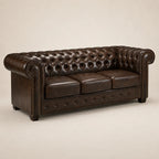 Luxury brown leather Chesterfield sofa with tufted back and rolled arms, perfect for elegant living rooms.