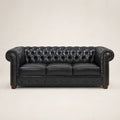 Black leather Chesterfield sofa with tufted back and rolled arms, luxury living room furniture