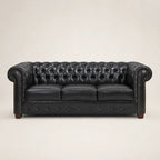 Black leather Chesterfield sofa with tufted back and rolled arms, luxury living room furniture