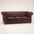 Luxury burgundy leather Chesterfield sofa with tufted back and rolled arms, ideal for elegant living rooms.