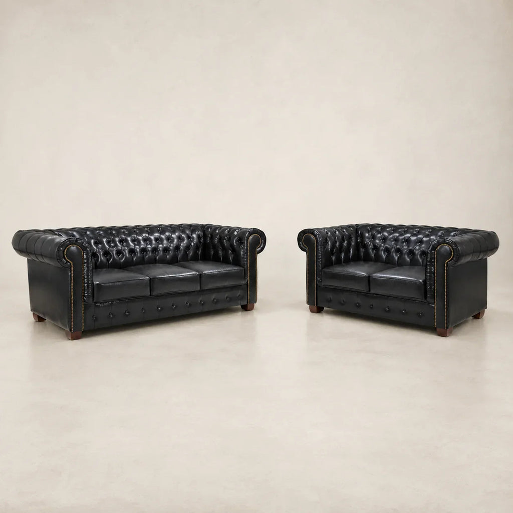 Black leather Chesterfield sofa and loveseat set with tufted design and rolled arms
