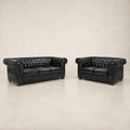Black leather Chesterfield sofa and loveseat set with tufted design and rolled arms