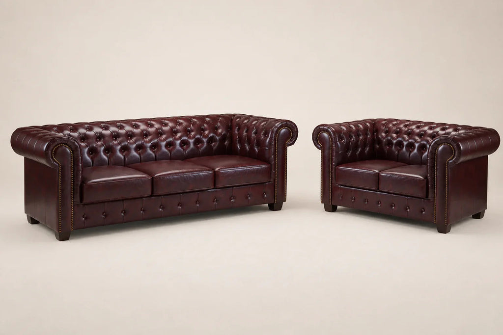 Luxury burgundy leather Chesterfield sofa and loveseat set with tufted upholstery and rolled arms