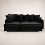 Luxury black velvet sofa with plush cushions and modern chrome feet, ideal for contemporary living rooms.