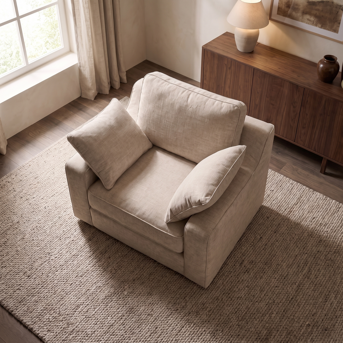 Alderley Armchair — elevated camera view in a warm stone and walnut living room