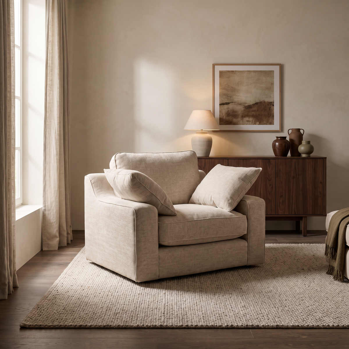 Alderley Armchair in an aspirational warm stone and walnut living room, natural daylight and realistic fabric texture