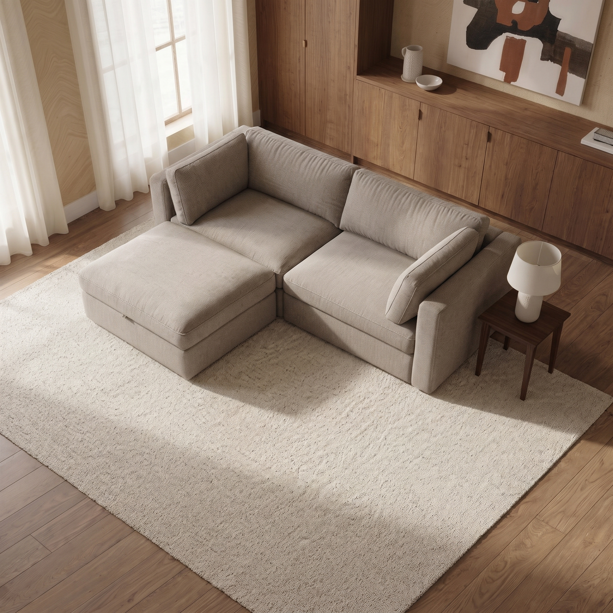 Bellano 2 Seater Sofa + Storage Ottoman — elevated camera view in a warm stone and walnut living room
