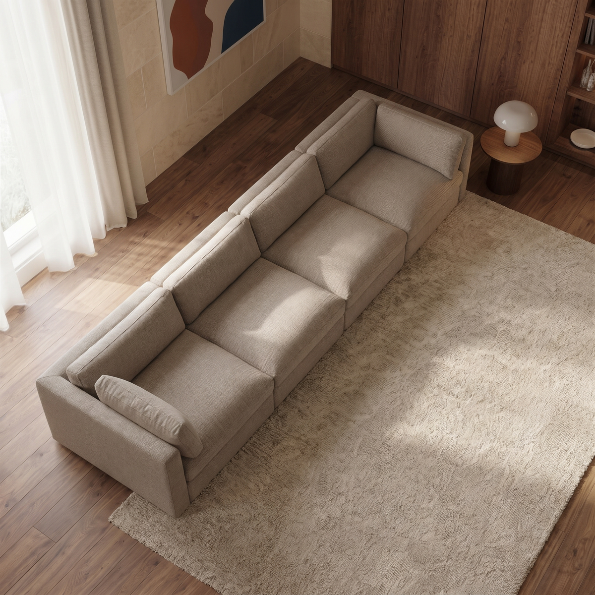 Bellano 4 Seater Sofa — elevated camera view in a warm stone and walnut living room