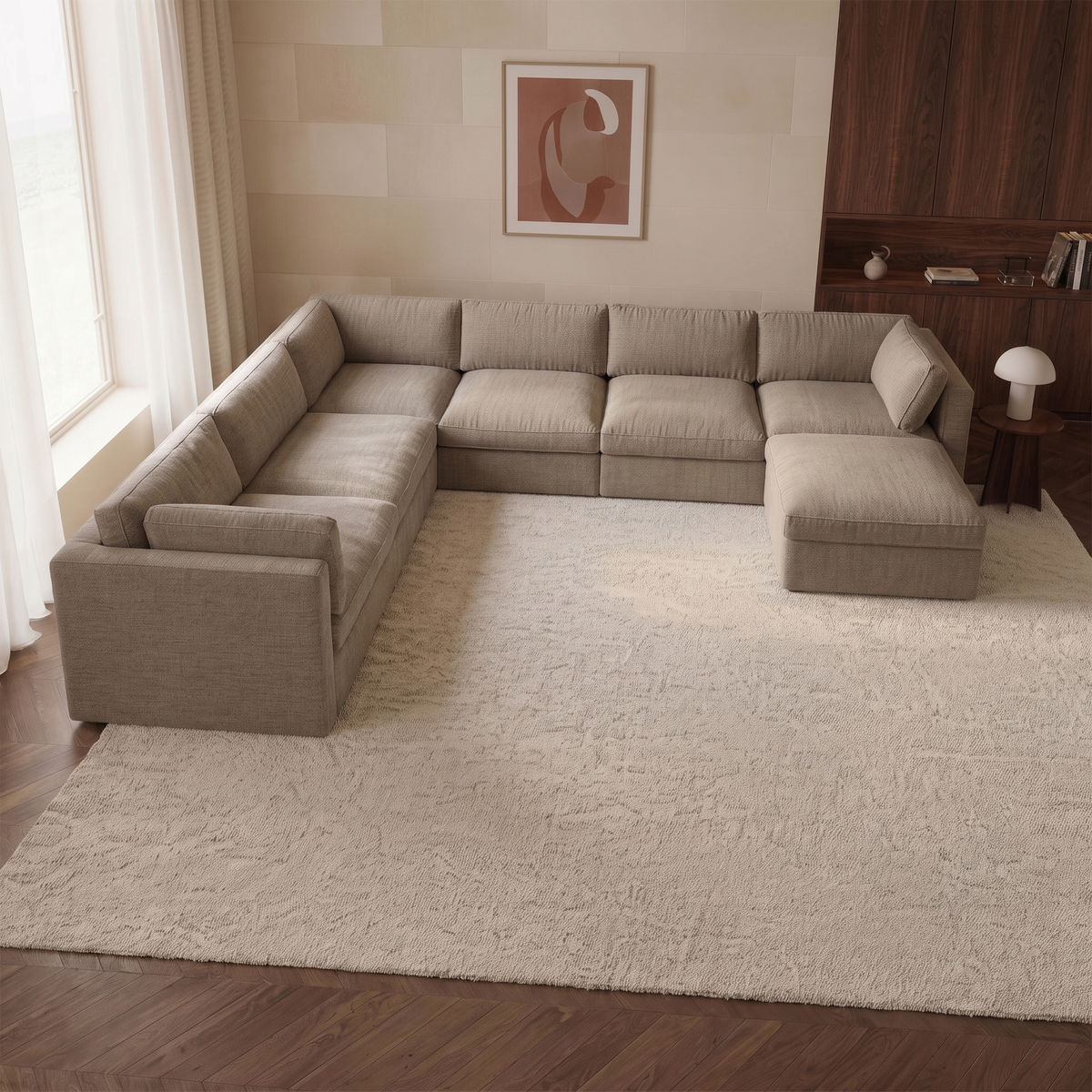 Bellano Grand Corner Sofa + Storage Ottoman — elevated camera view in a warm stone and walnut living room