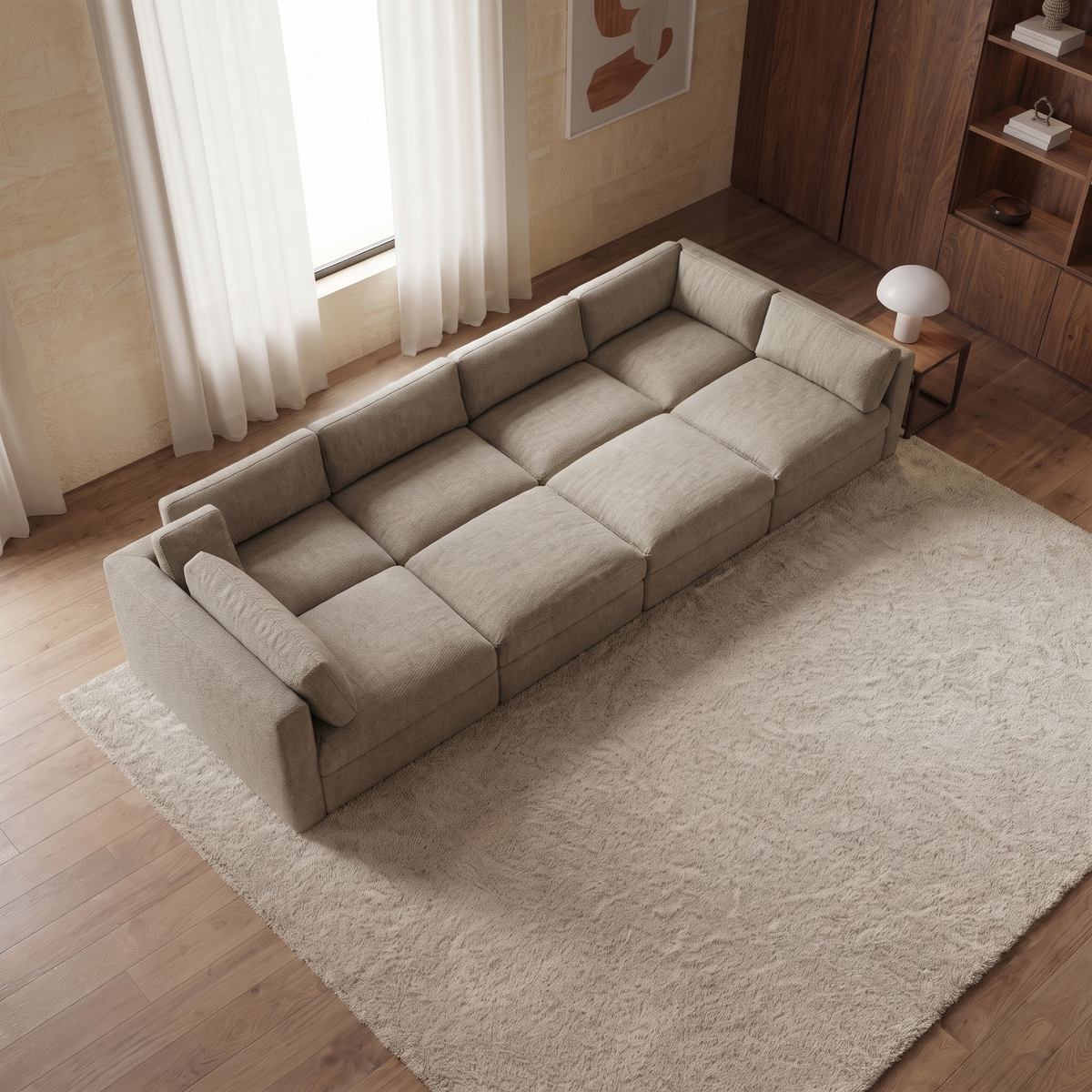 Bellano Grand Pit Sofa + Storage Ottoman — elevated camera view in a warm stone and walnut living room