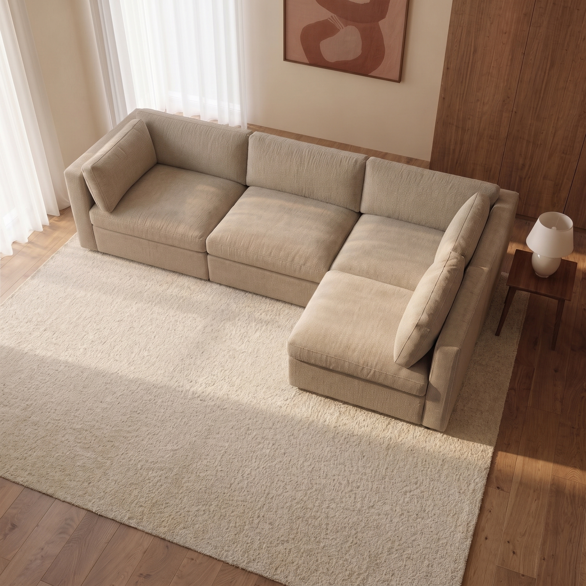 Bellano L-Shape Sofa + Storage Ottoman — elevated camera view in a warm stone and walnut living room