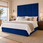 Four Blue Plush Velvet 45cm wall panels behind a matching upholstered bed base in a styled bedroom. Room visualisation; panels sold individually, base and styling separate.