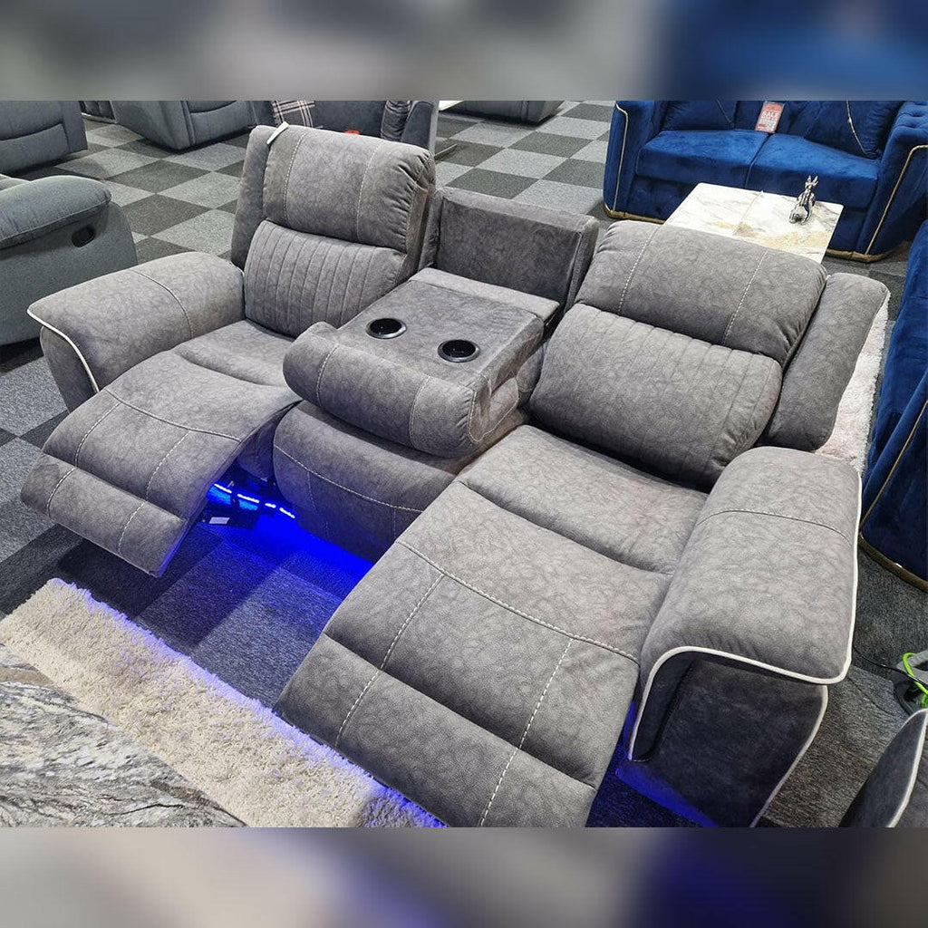 Grey electric recliner sofa set with cup holders and blue LED lighting in showroom