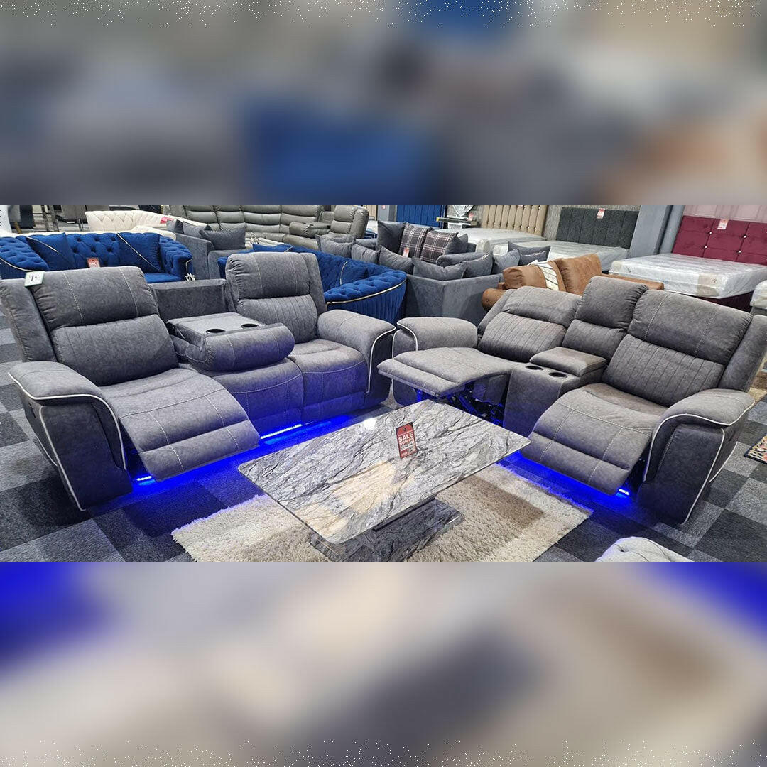 Grey microfibre electric recliner sofa set with cup holders and LED lights in showroom