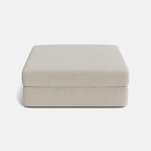 Beige modular ottoman with cushioned top, minimalist design, isolated on white background.
