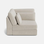 Beige modular corner sofa with plush cushions, modern design, shown on white background