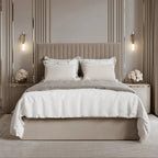 Cream upholstered ottoman bed with panelled headboard in modern luxury bedroom setting