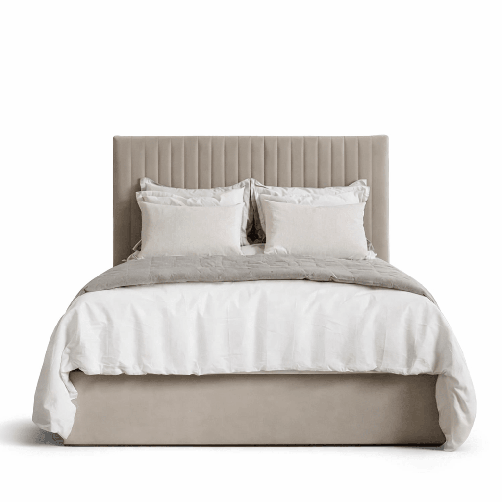 Cream upholstered bed with panelled headboard and plush bedding, modern luxury style