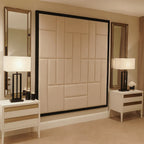 Wall-mounted upholstered headboard in modern bedroom with bedside tables and lamps