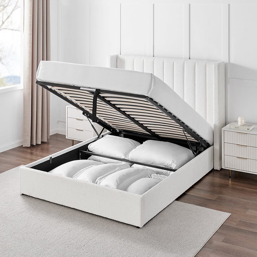 Modern double boucle ottoman storage bed in white with gas lift open, showing bedding inside