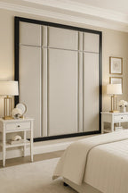 Luxury upholstered headboard with black frame in modern bedroom, paired with white nightstands and lamps