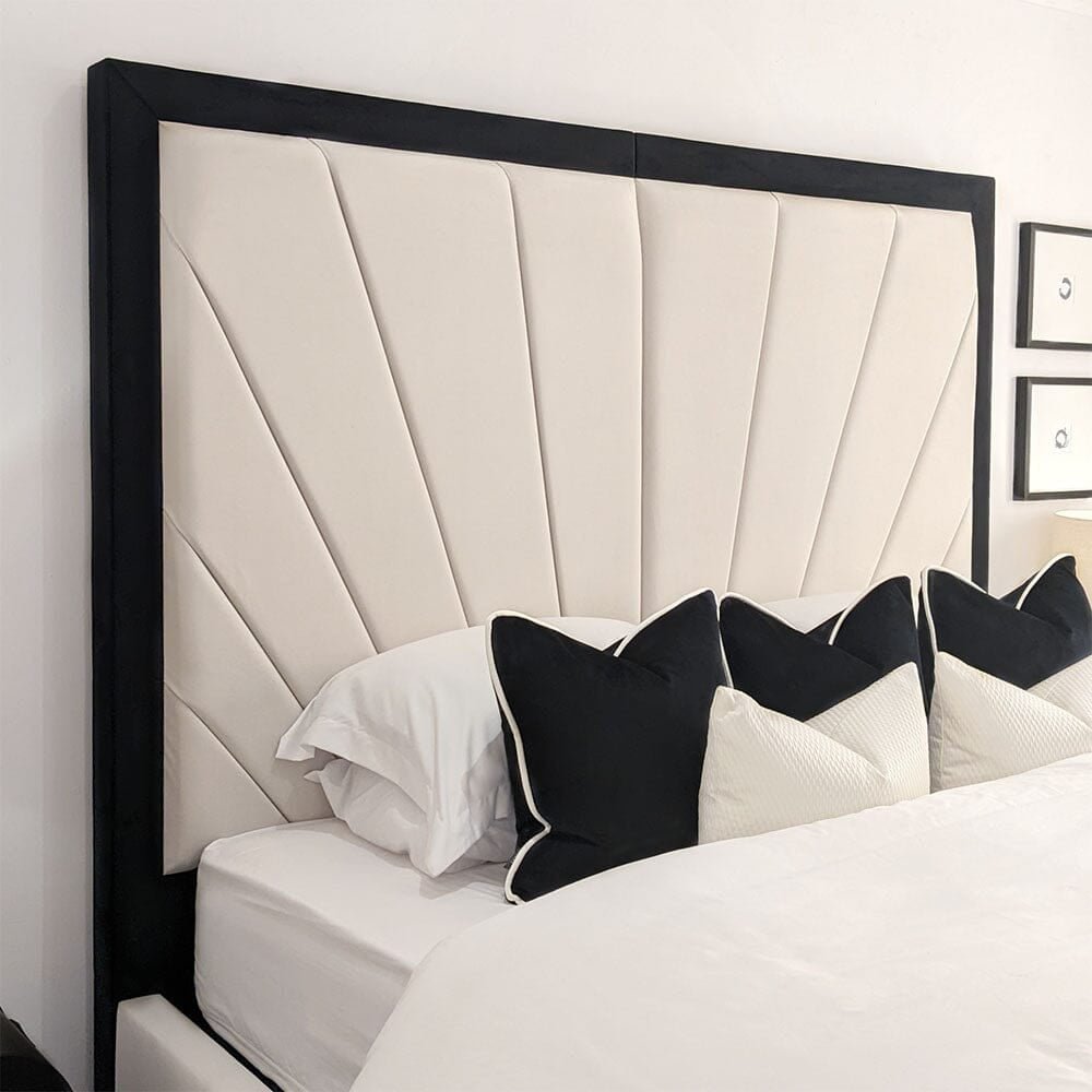 Modern double bed with cream sunburst headboard and black trim, styled with monochrome pillows