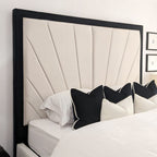 Modern double bed with cream sunburst headboard and black trim, styled with monochrome pillows