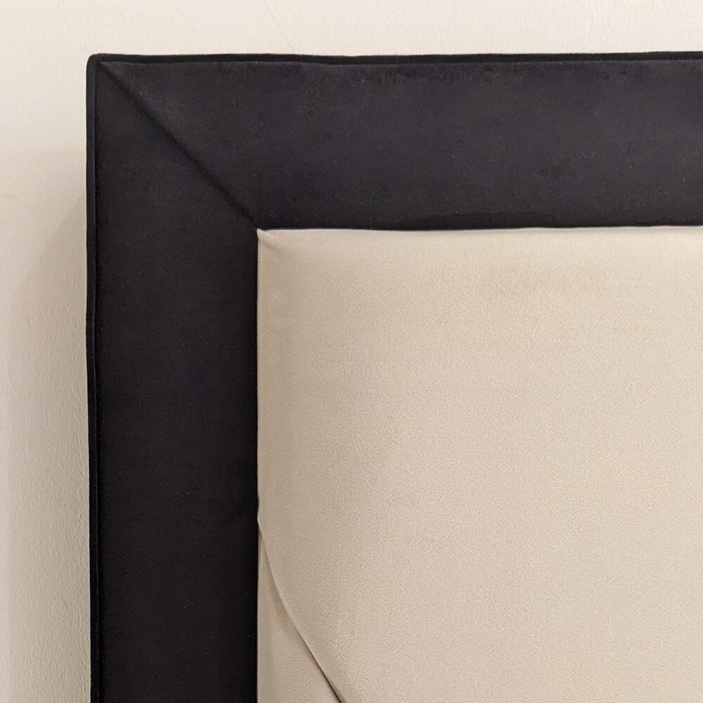 Close-up of modern double bed with sunburst padded headboard in cream and black fabric