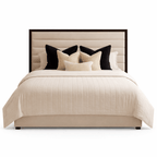 Modern panelled bed with cream upholstery, dark trim headboard, and decorative pillows