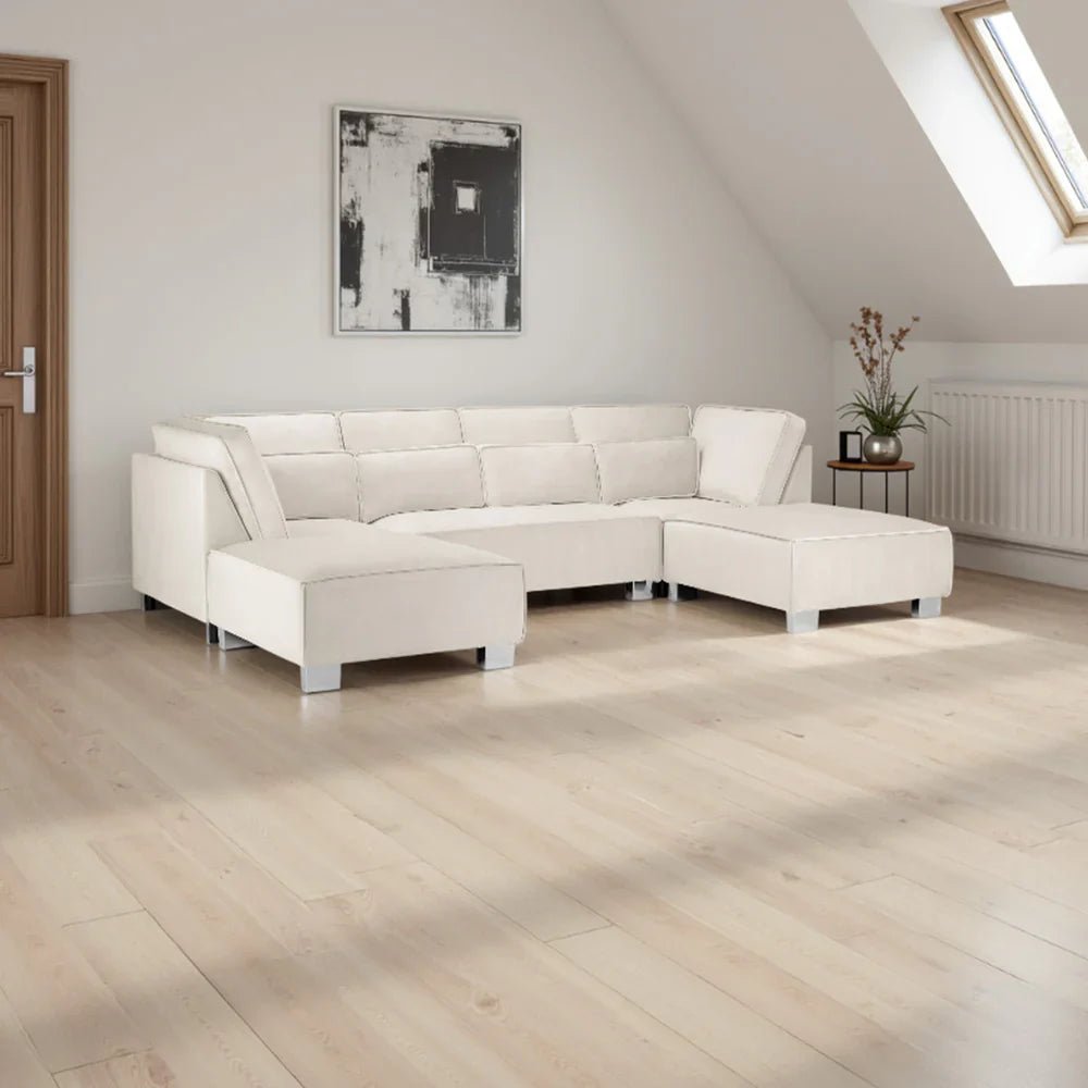 Modern U-shape corner sofa in cream upholstery in a bright living room with wood floors