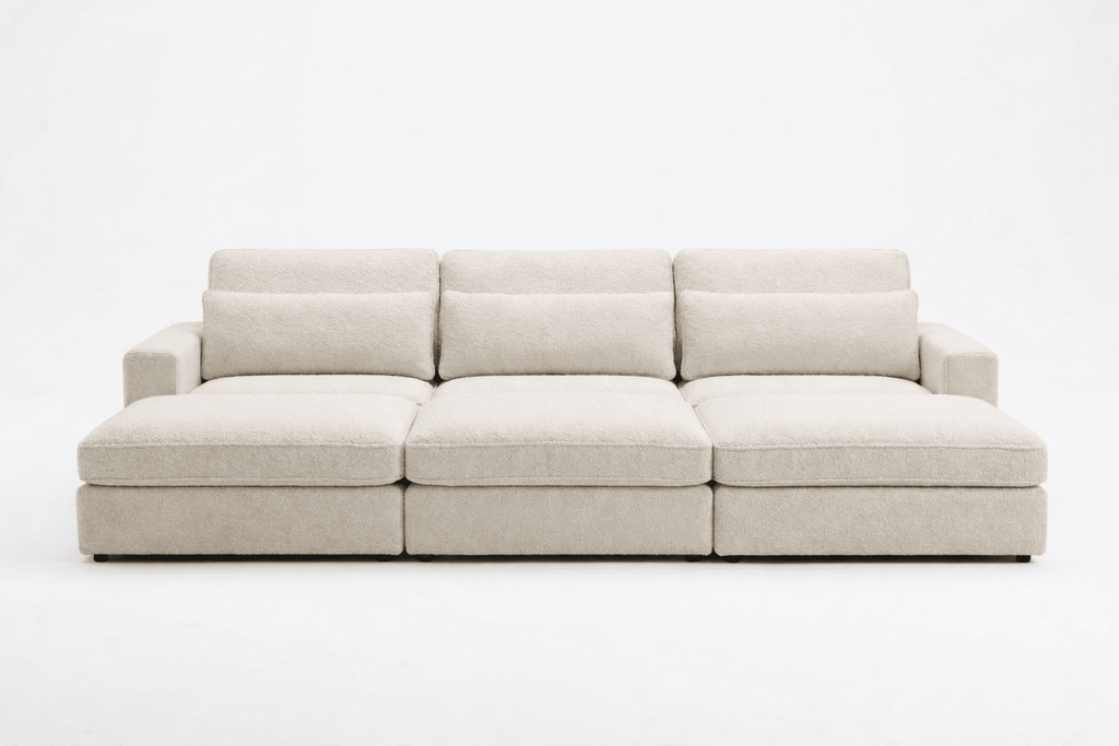 Modern cream fabric cinema sofa with wide armrests and plush cushions, three-seater design