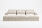 Modern cream fabric cinema sofa with wide armrests and plush cushions, three-seater design