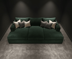Large dark green cinema sofa with multiple grey and cream cushions in a modern room