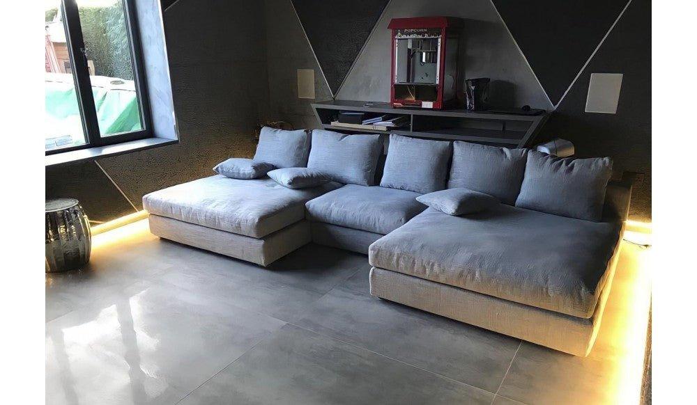 Modern living room with spacious silver cinema sofa, soft cushions, and underglow lighting
