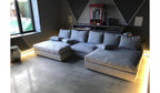Modern living room with spacious silver cinema sofa, soft cushions, and underglow lighting