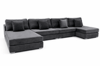 Large modern dark grey velvet sectional sofa with matching cushions and chaise lounge