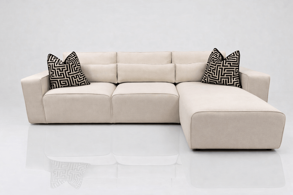 Cream left-hand facing corner sofa with chaise, geometric black and white cushions