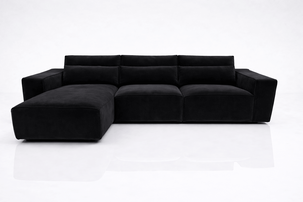 Modern black corner sofa with left-hand chaise and wide armrests on white background