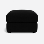 Modern cream upholstered footstool with soft cushioning on a plain white background
