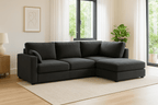 Modern dark grey corner sofa with chaise lounge in a bright living room