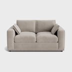 Modern cream two-seater sofa with clean lines and two matching side cushions