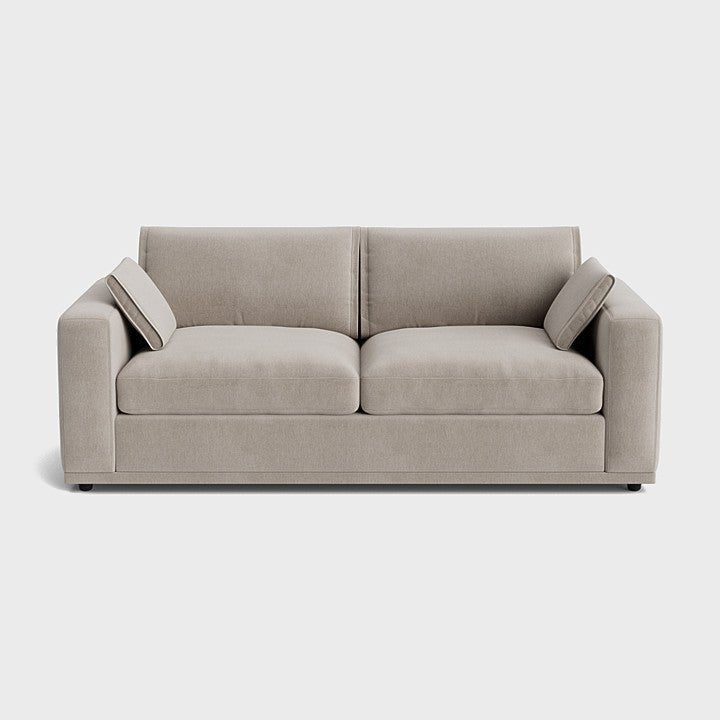 Modern cream corner sofa with wide armrests and plush cushions on a white background