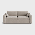 Modern cream corner sofa with wide armrests and plush cushions on a white background