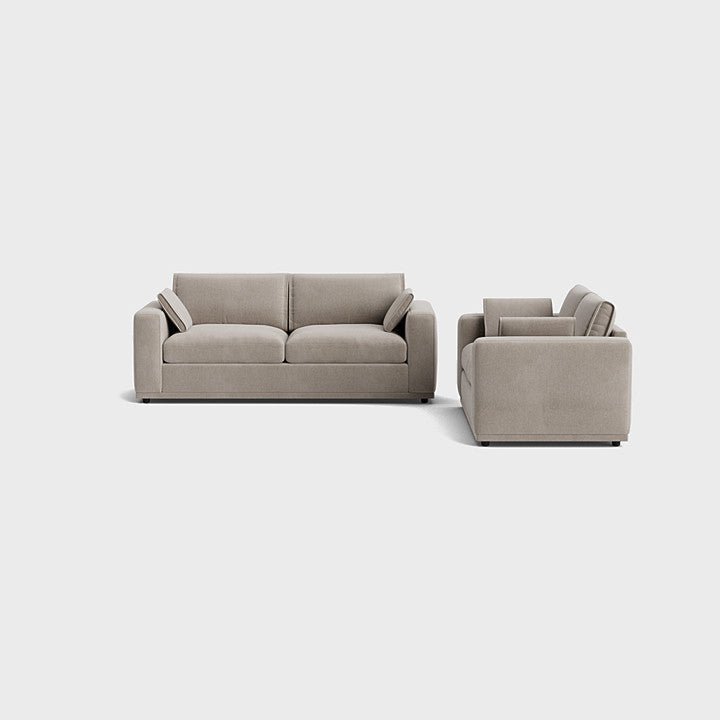 Modern cream corner sofa with plush cushions and wide armrests on light background
