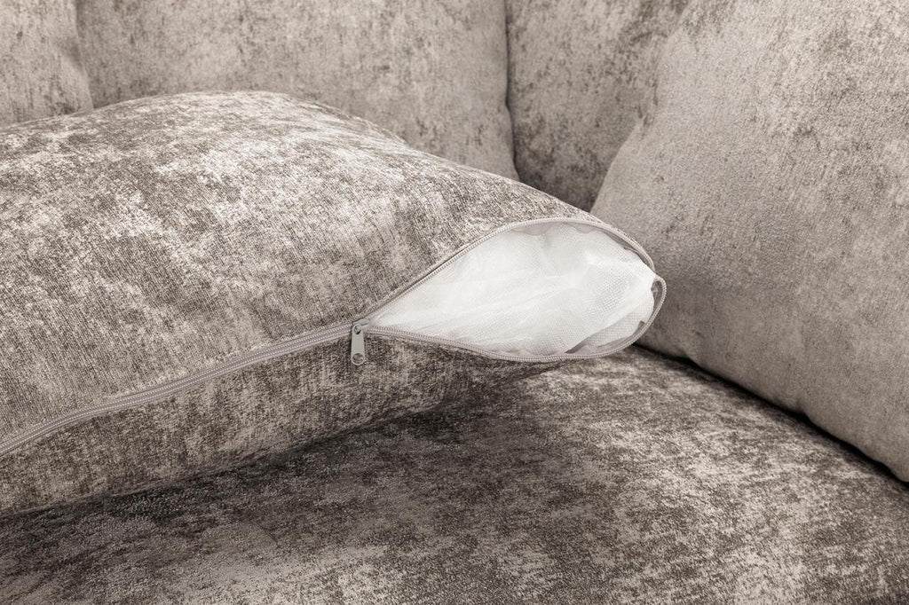 Close-up of a grey textured sofa cushion with a visible zip opening and inner lining